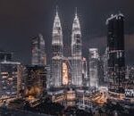 A breathtaking night view of Kuala Lumpur's skyline featuring the illuminated Petronas Towers.