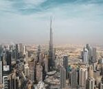 A breathtaking aerial view of Dubai's skyline featuring Burj Khalifa amidst modern skyscrapers under a clear sky.