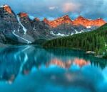 Capture the serene beauty of Moraine Lake with sunrise reflections in Banff National Park.