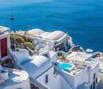 Whitewashed Santorini architecture overlooking the deep blue Aegean Sea.