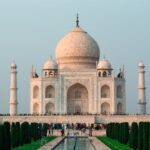 A stunning shot of the Taj Mahal in Agra, showcasing its iconic architecture and serene surroundings.